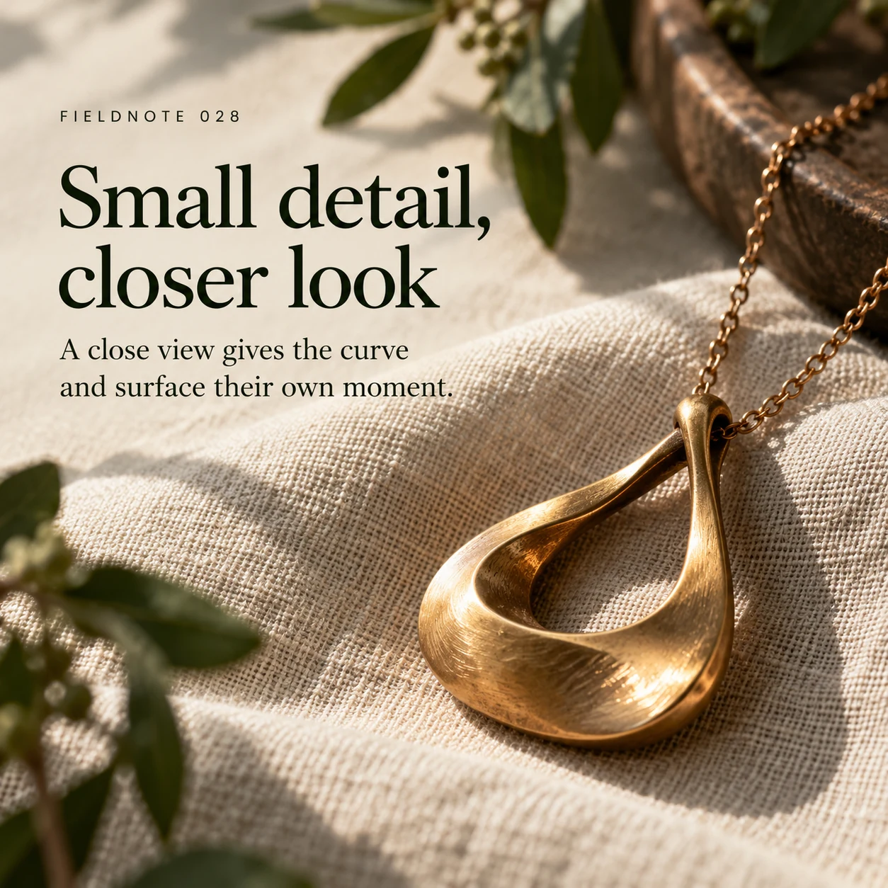Illustrative campaign concept: close view of original pendant curve on linen, with the headline “Small detail, closer look” and fictional FIELDNOTE branding.