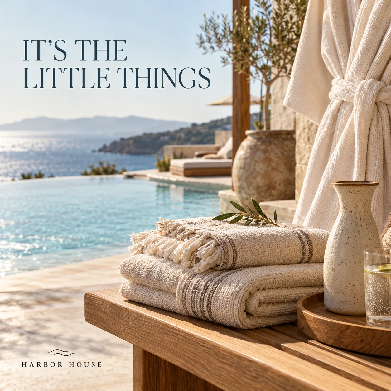 Illustrative boutique-hotel amenities with towels, robe and water carafe